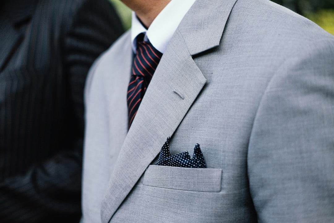 A businessman in a gray suit and striped tie exemplifies professionalism, highlighting how a custom website can enhance business image and success.